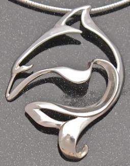 designer sterling silver dolphin pendant on grey background